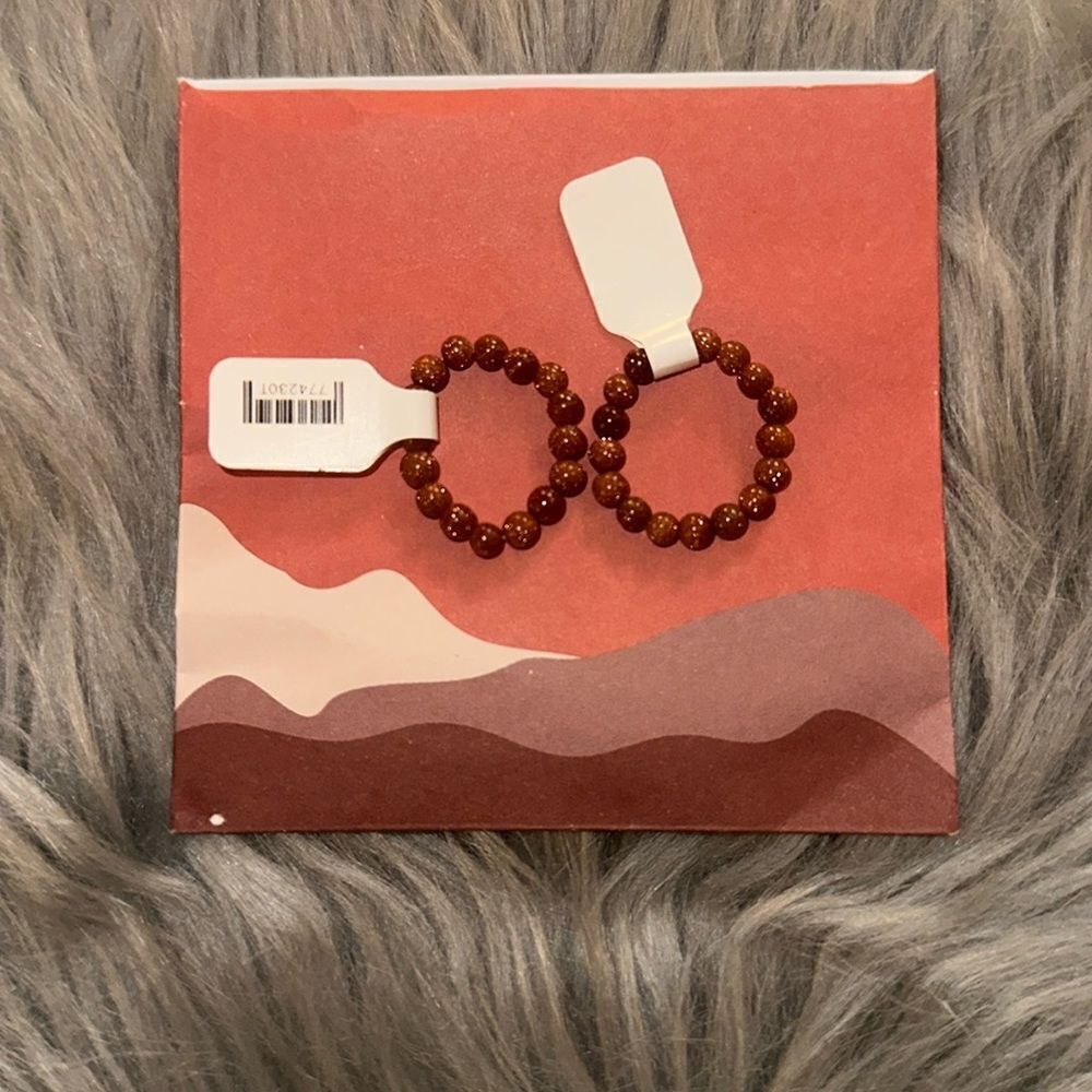 2 Goldstone stone energy rings. Brand new